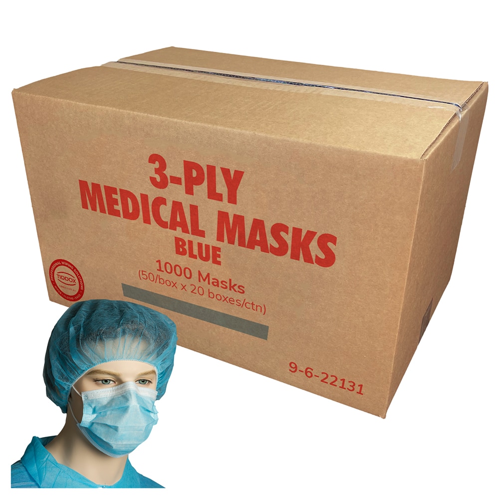 A mannequin head wearing a blue hair net and blue medical mask with a cardboard box in the background with lard red writing