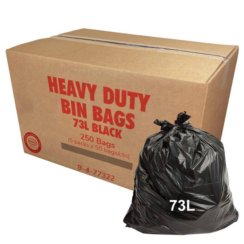 A carboard with red writing and a black bin liner at the bottom right corner with a 73L