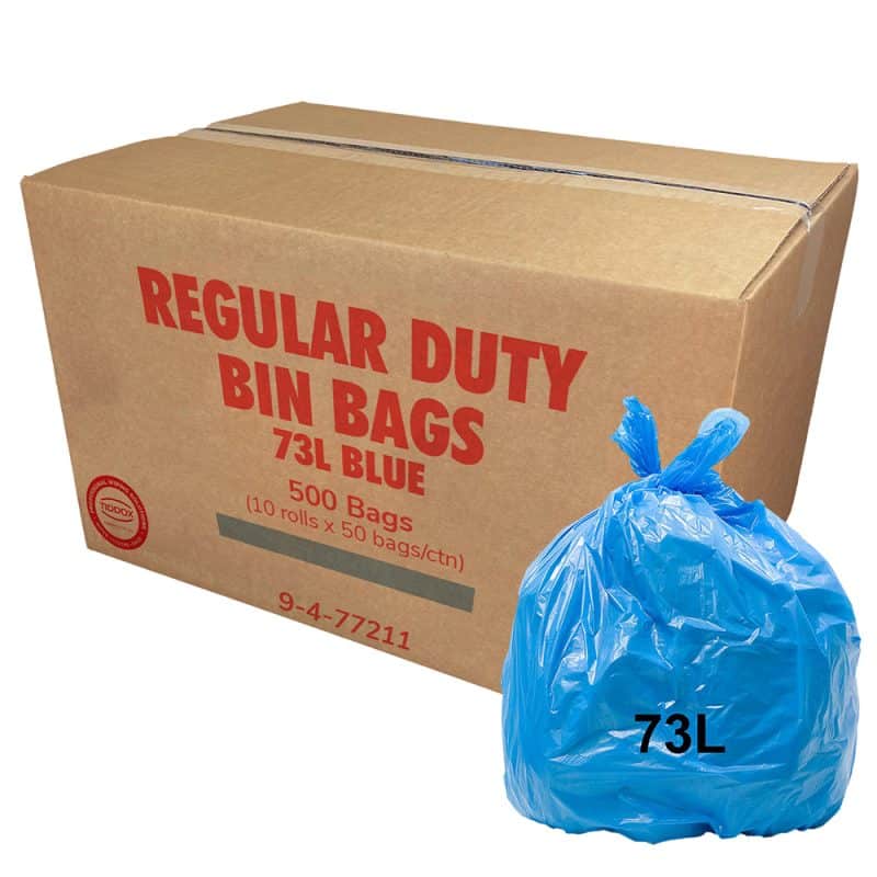 A carboard with red writing and a blue bin liner at the bottom right corner with a 73L