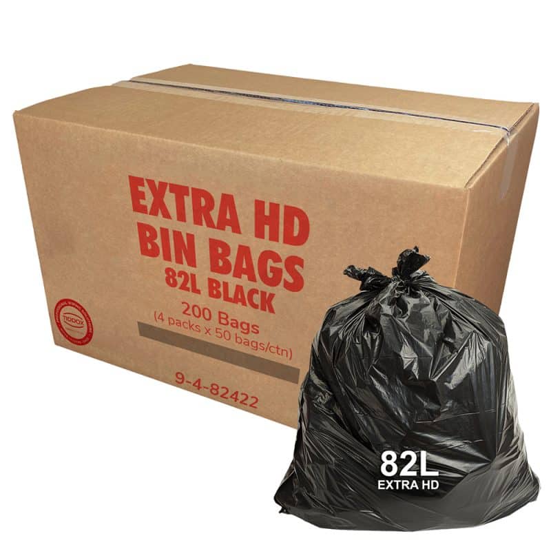 A carboard Box with red writing and a black bin liner at the bottom right corner with a 82L