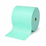 Jumbo wipes roll green roll stacked on it's side on a plain background with a wipe comeing off the roll