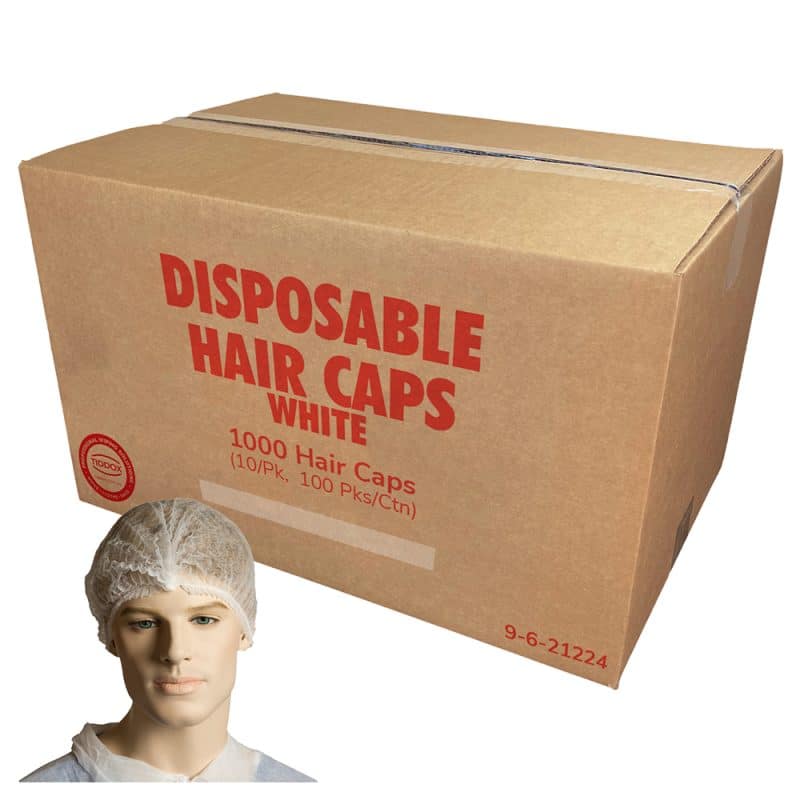 A mannequin displaying white disposable hair caps, with a carton box with red writing