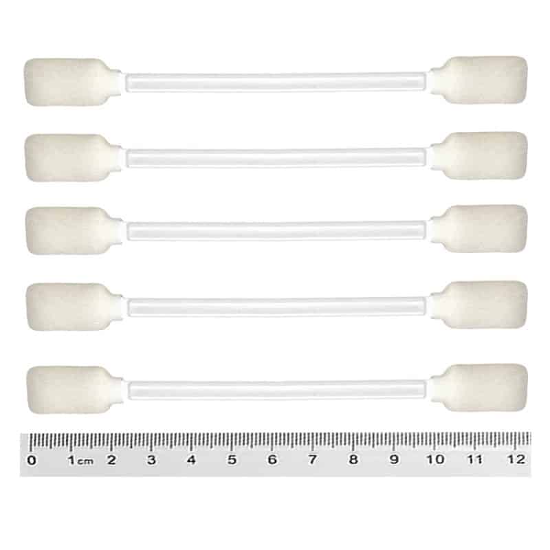 Horizontally stacked white foam swabs with a measuring tape positioned at the bottom to indicate size.