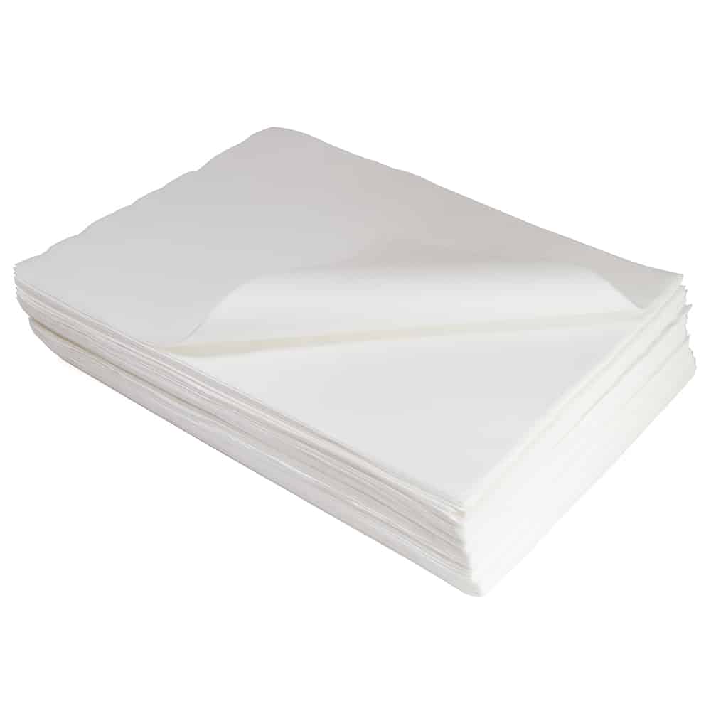 Well-arranged stack of white wipes with the top wipe gracefully curved at an angle against a plain background.