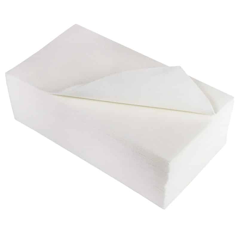 Neatly stacked wipes top wipe curved to the side open with a plain background