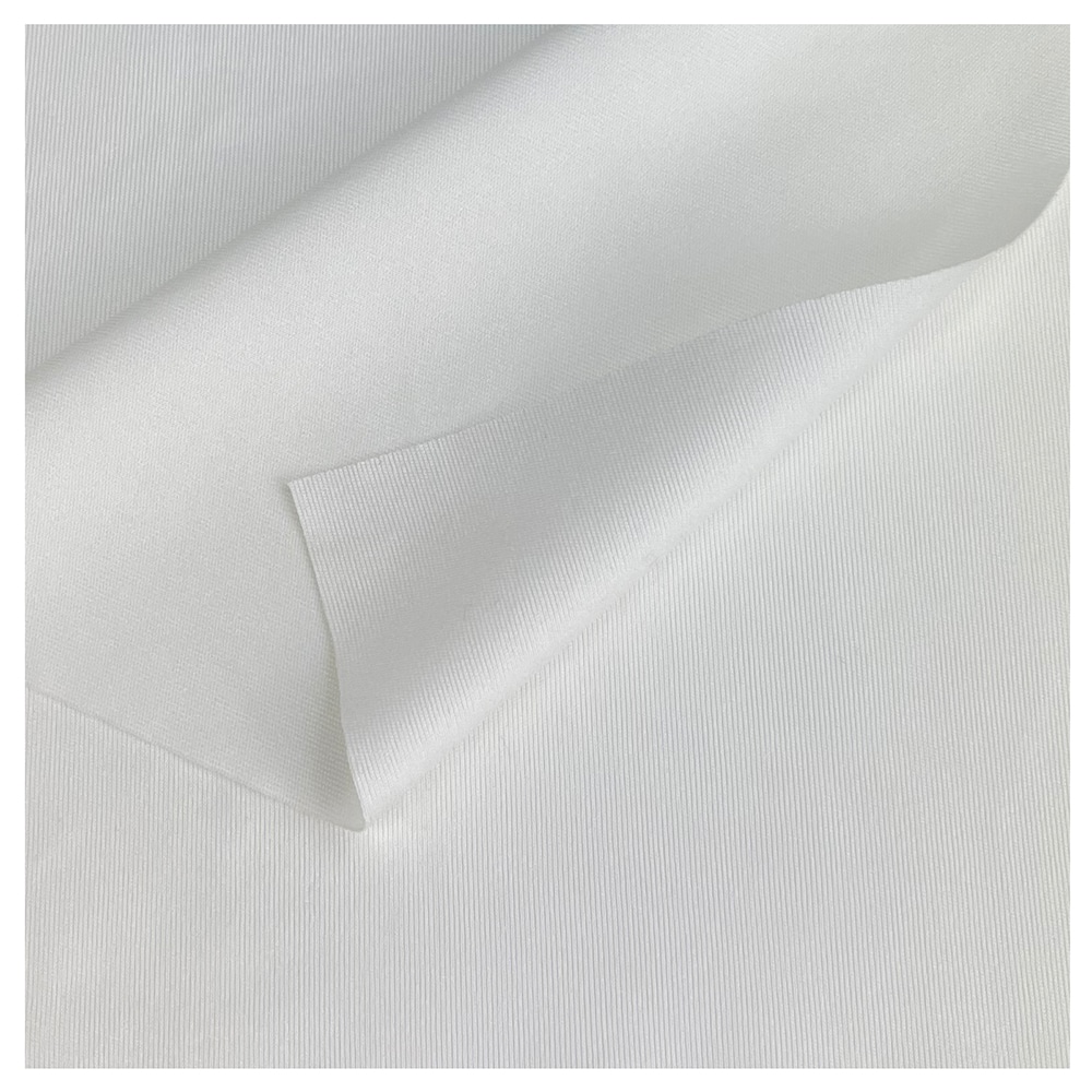 A close up of a white polyester wipe with the top left corner curved over itself