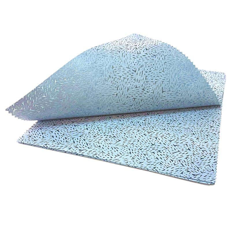 Blue-patterned sheets on a white backdrop with the top sheet curved upward