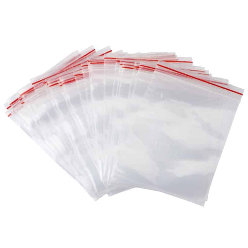 A fanout pile of clear resealable bags with a red zipper