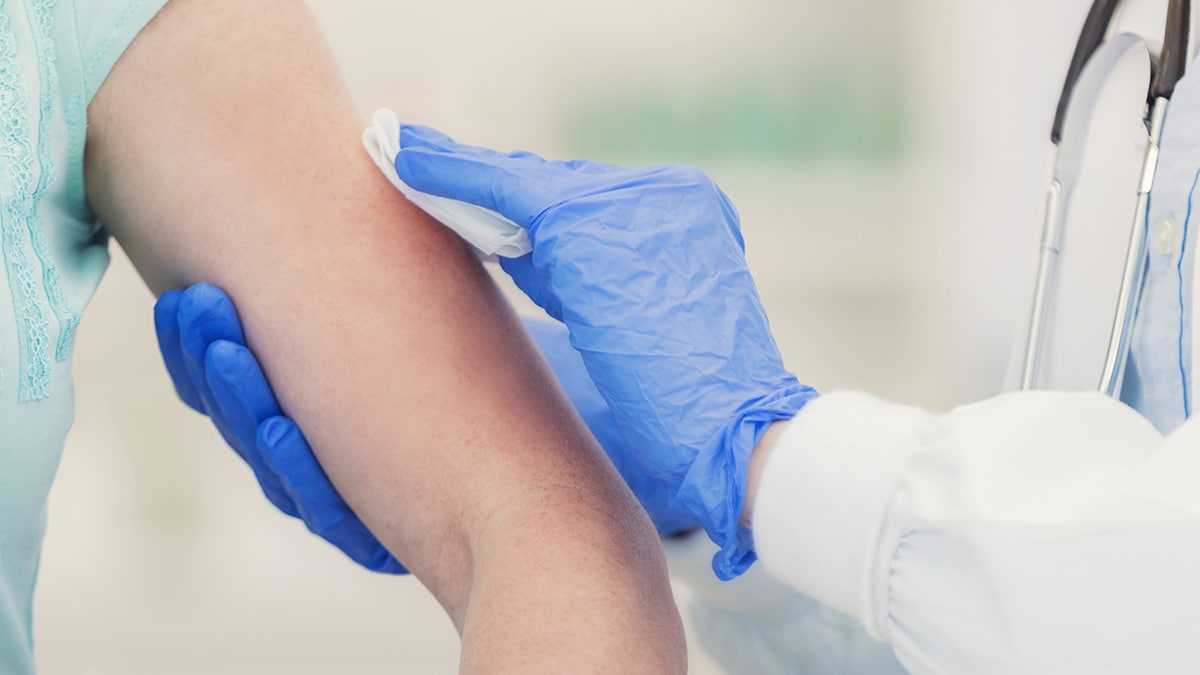 Unrecognizable patient is about to receive an arm injection using Cotton Nonwoven Cleanroom Wipes