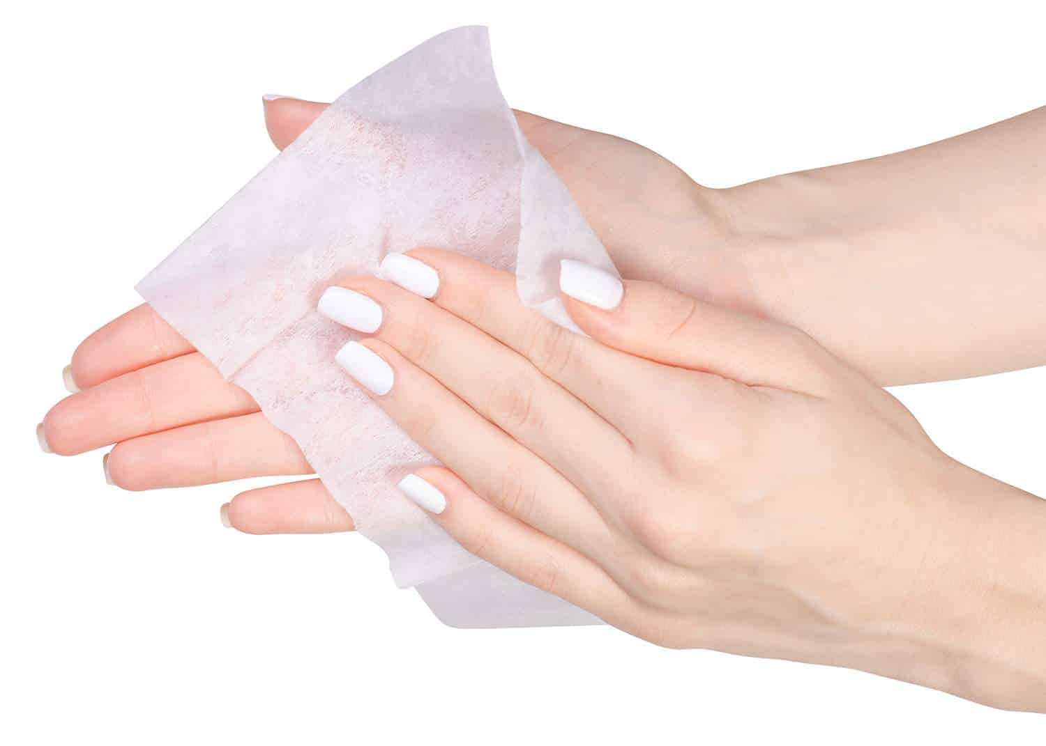 Female hand wet wipe on white background isolation, top view